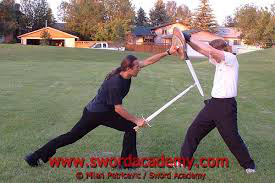 weapons experts using sword and buckler in modern day combat